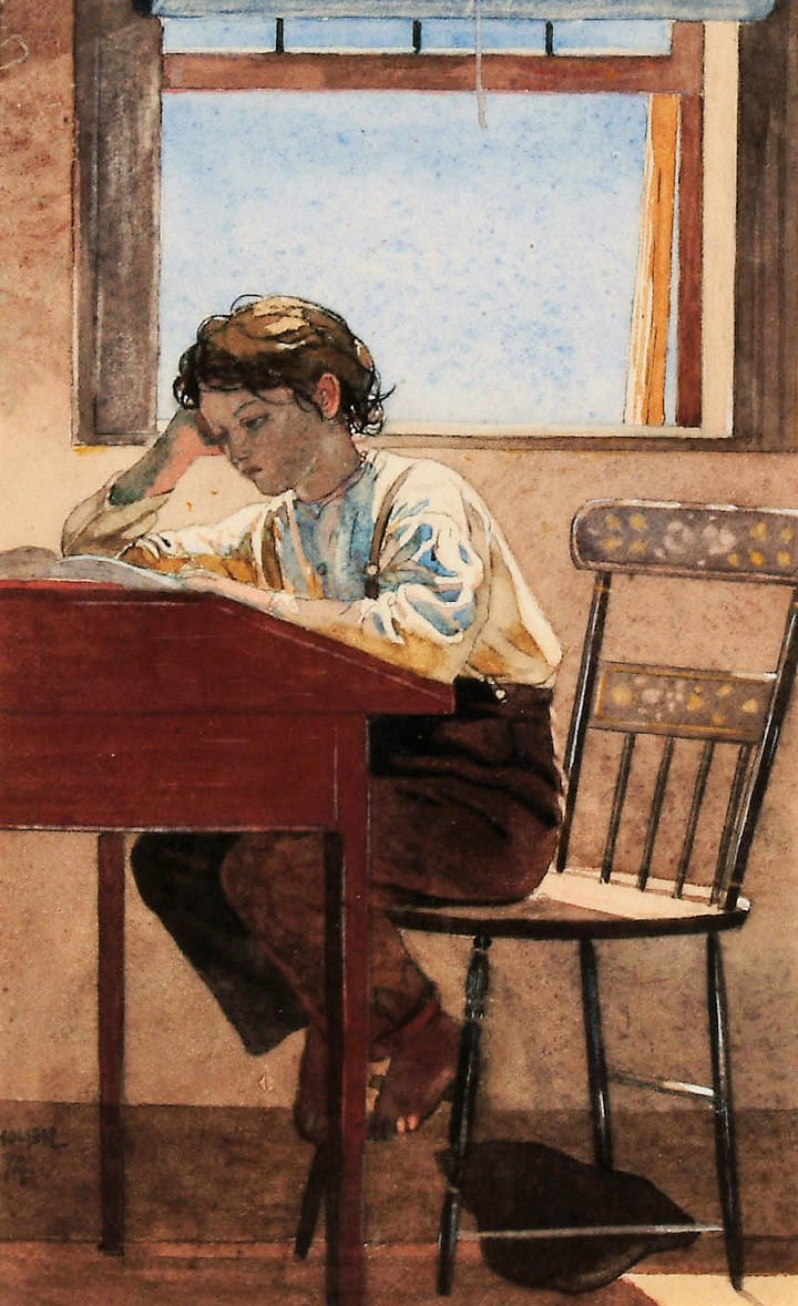 A boy sits at a wooden red desk. He has brown hair and pale skin. He wears a loose white shirt and brown pants held up by suspenders. He leans on the desk over a book, his expression is one of studiousness or boredom. 